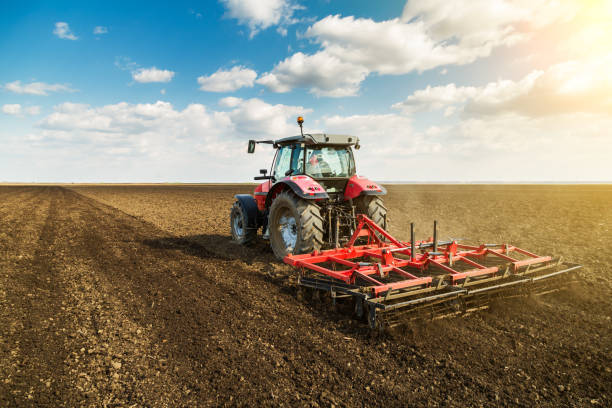 istock Farmer in tractor preparing land with seedbed cultivator. 640292116