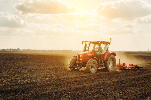 istock Farmer in tractor preparing land with seedbed cultivator. 640292278