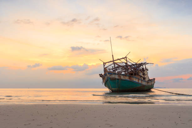 istock abandoned boat at beach in twilight 640294542