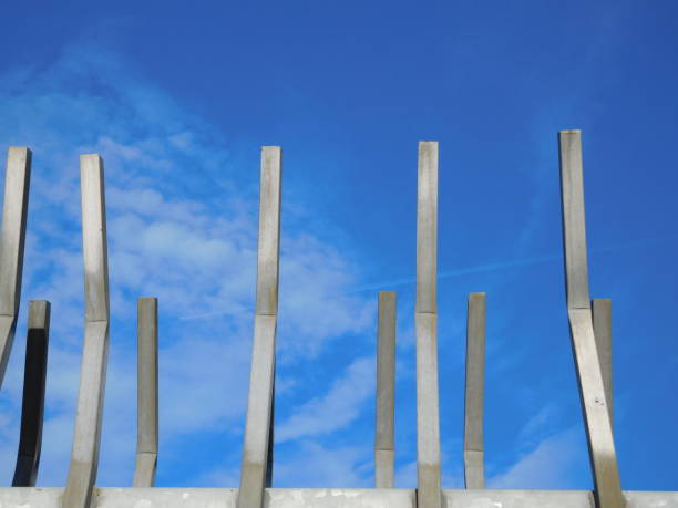 Bent steel bars profiled against blue Oregon sky.