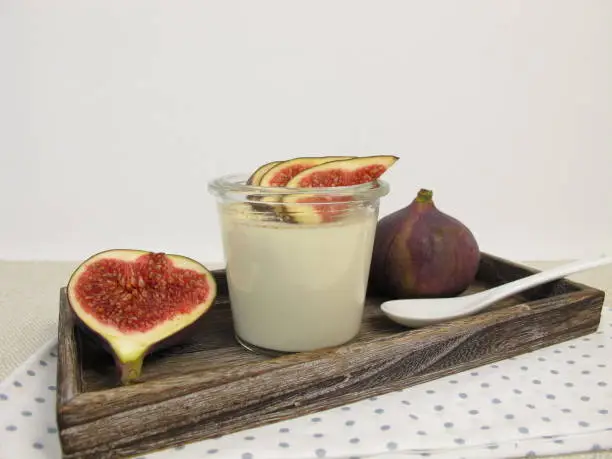 Panna cotta with cinnamon in jar and figs garnish - Panna Cotta with cinnamon in the glass and a garnish of figs 