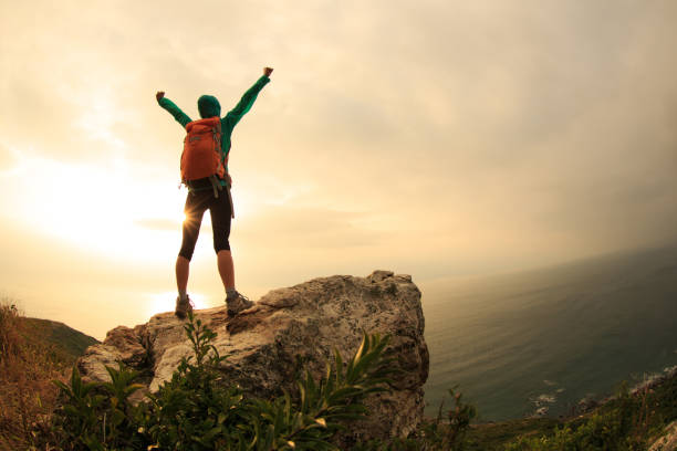 istock successful hiker hiking on seaside mountain peak 640302362