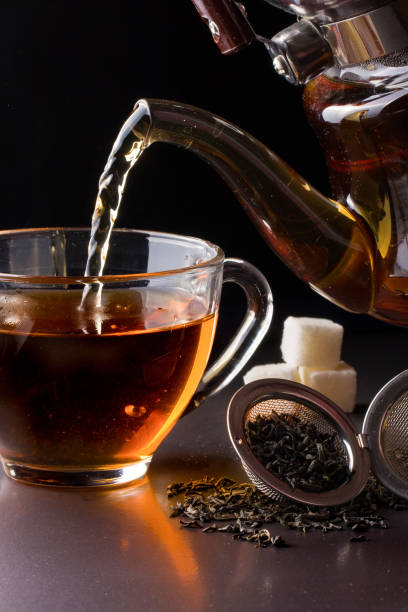 istock cup of tea with teapot on dark background 640302760