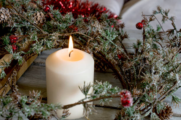 istock Still life of three candles burning with green branches 640306700