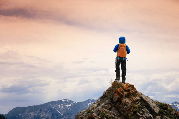 successful woman backpacke hiking  on mountain peak