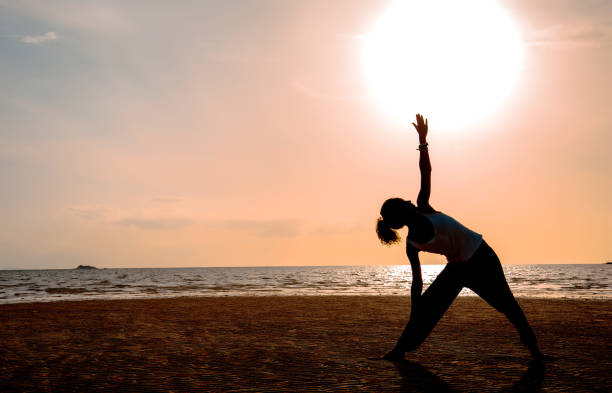 istock Silhouette young woman practicing yoga 640307678