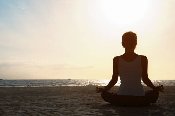 istock Silhouette young woman practicing yoga 640307738