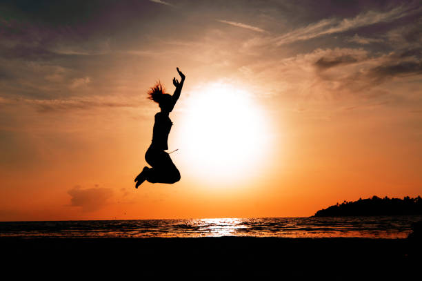 istock Happy woman jumping on sunset 640307814
