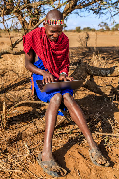 istock Warrior from Maasai tribe using laptop, Kenya, Africa 640313696
