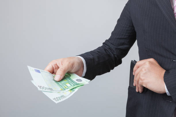 istock Business man holding bank notes out wallet. 640313748