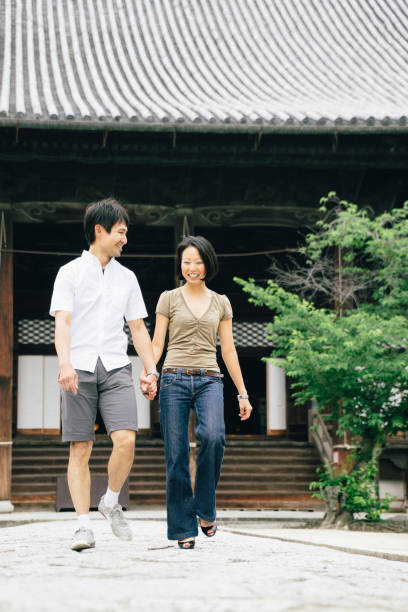 istock Cheerful japanese couple at the temple, front view 640315088
