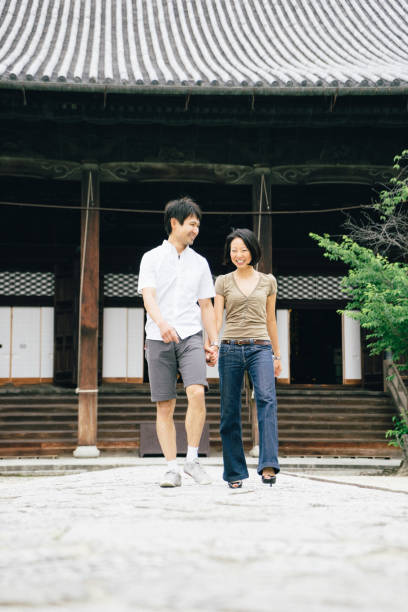 istock Cheerful japanese couple at the temple, front view 640316014