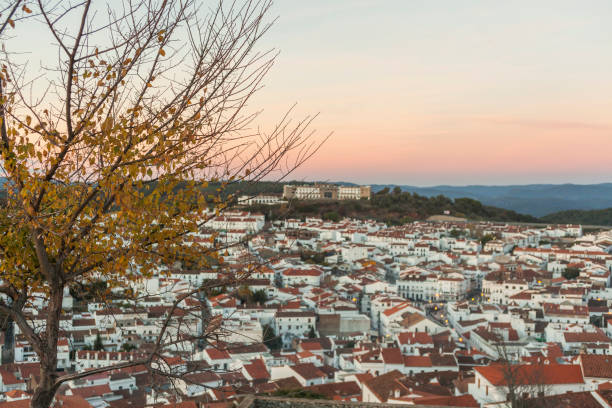 Foreground tree and tourist Aracena's town in the background stock photo