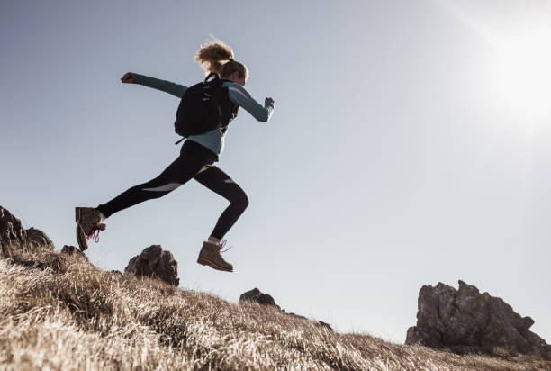 istock Female Hiker Running Across a Hill 640317654