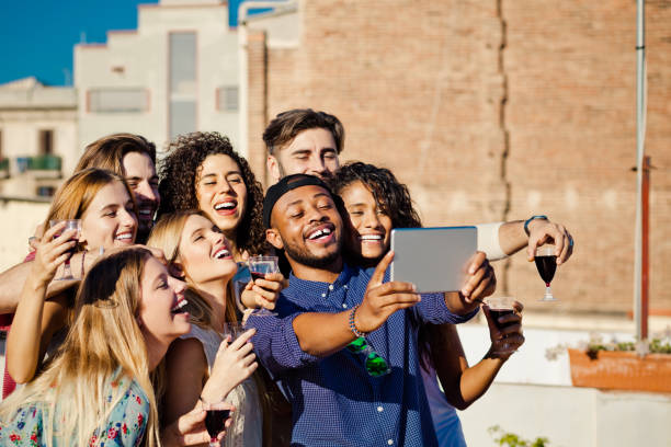 istock Happy friends taking selfie at rooftop party 640321654