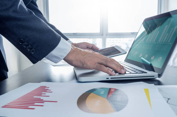 istock businessman working with digital tablet and laptop with financia 640322592