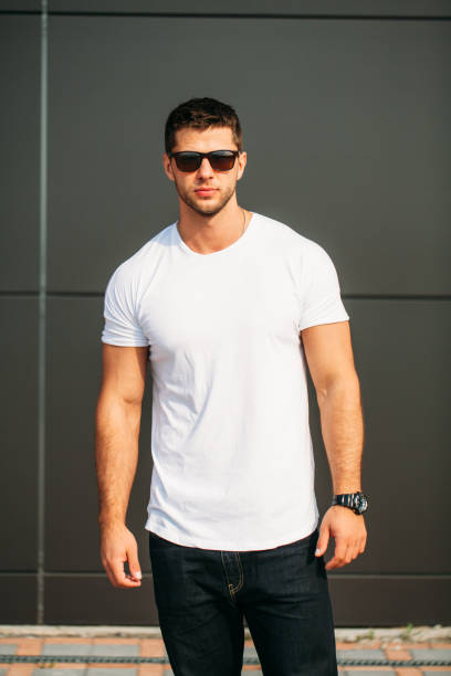 istock hipster wearing white blank t-shirt with space for your logo 640323498