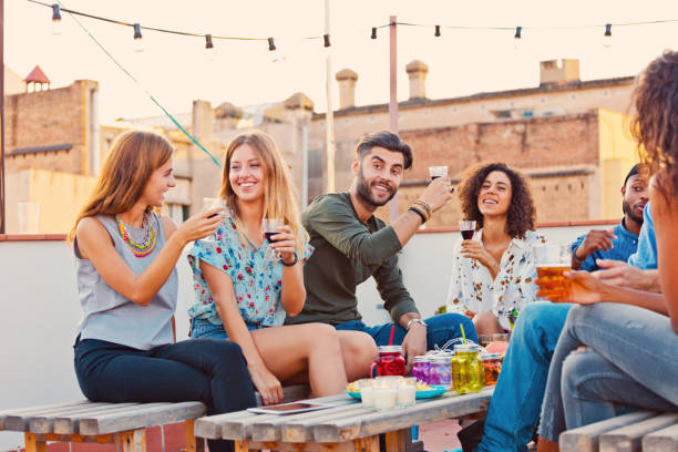 istock Friends at the rooftop party drinking red wine 640323514