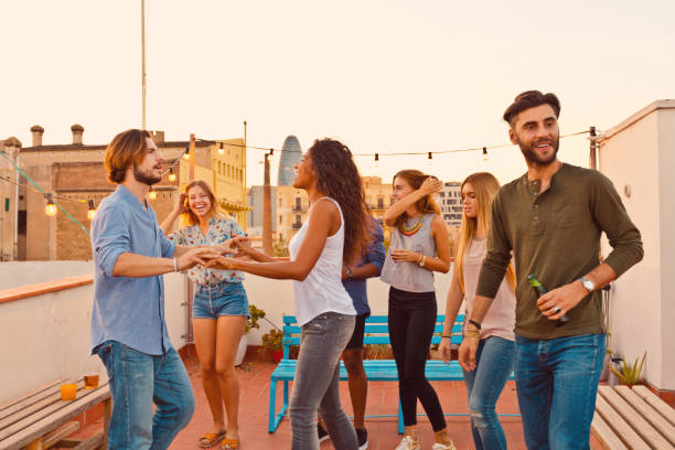 istock Happy friends dancing at the rooftop party 640324272
