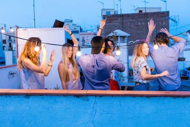 istock Happy friends dancing at the rooftop party 640325562