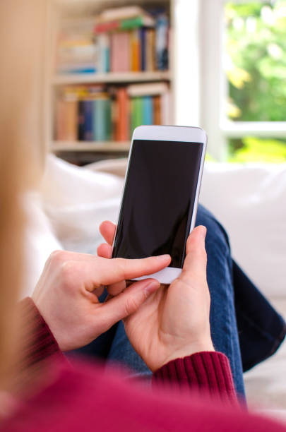 istock Woman holding blank smartphone with black screen and copy space 640326298