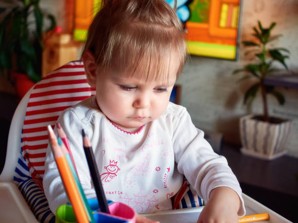 istock happy baby child draws with colored pencils crayons 640330668