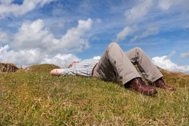 Mature Man sleeping in the Sun in the Countryside - 