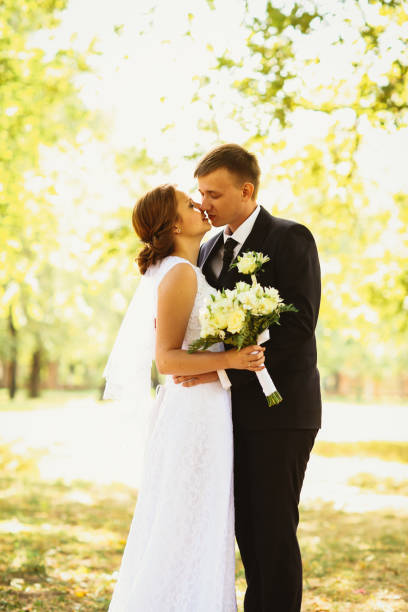 istock couple bride and groom on a park background 640332760