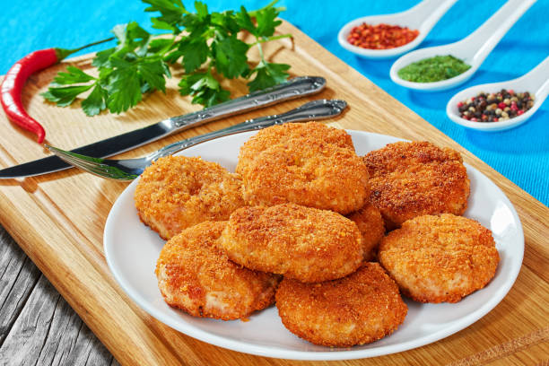 istock juicy delicious chicken, pork, beef breaded cutlets on white pla 640332900