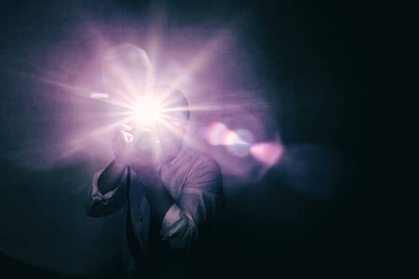 Young annoying fashion photographer in white shirt with sleeves Young man takes a picture on a camera with built-in flash. Bright light for illumination of the frame. cameras flashing stock pictures, royalty-free photos & images