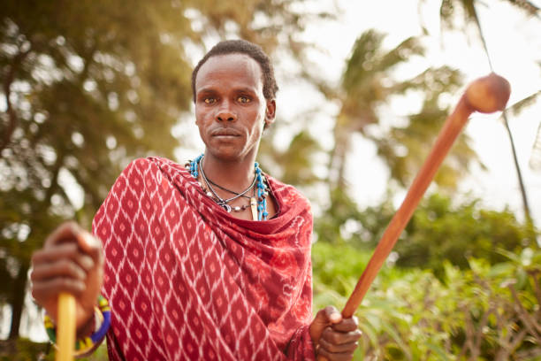 istock Elegant Maasai man standing under Zanzibars palm trees. 640332962