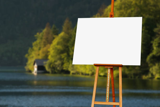 istock Blank painter artist canvas on easel with lake in background 640333582