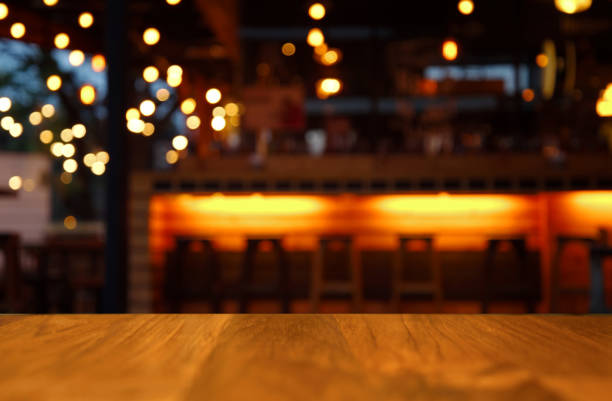 istock wood table for display with light blur night bar background 640333682
