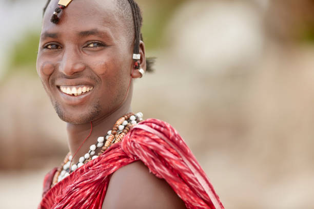 Elegant Maasai man standing under Zanzibar's palm trees.