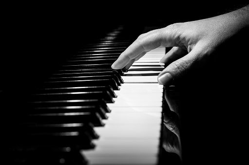 piano player hand in a piano keyboard