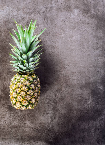 istock ripe pineapple on a stone background 640335490