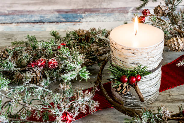 istock Still life of three candles burning with green branches 640336952