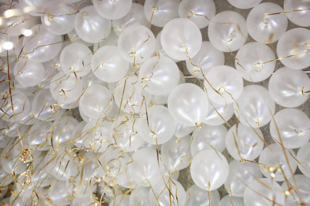 istock Many white balloons with gold ribbon ceiling 640336986