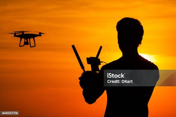 Silhouette Of Man Operating Drone Stock Photo - Download Image Now - Control, Drone, Adult