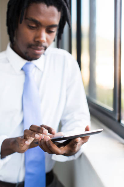 istock African businessman reading emails from a digital tablet. 640337866