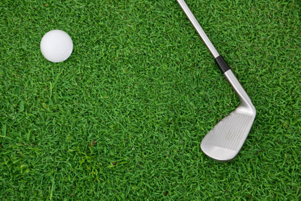 istock iron golf club and ball on a green grass 640338334