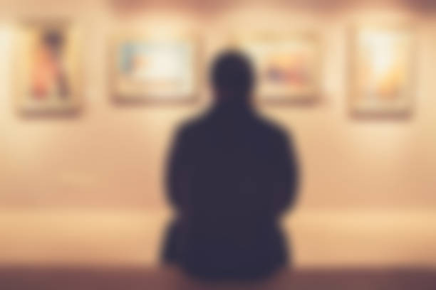 istock Man sitting on a bench at an exhibition gallery 640338442