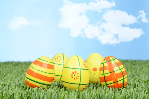 istock closeup of yellow and orange easter eggs 640338578