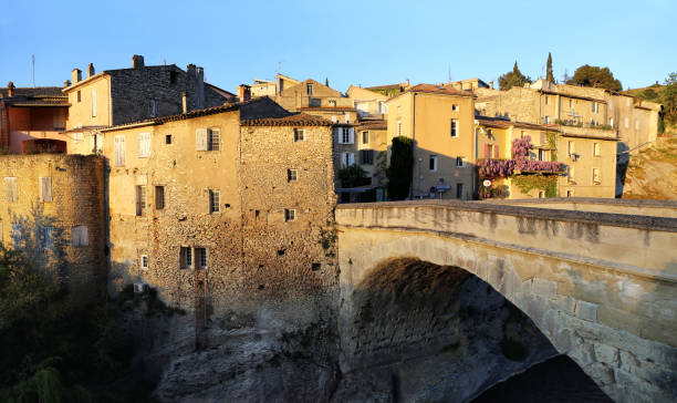 istock Nyons village,  Medieval bridge at sunset 640342158