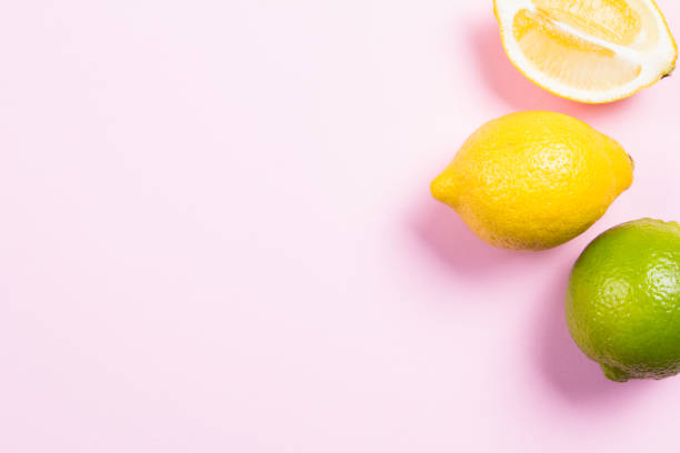 istock Several kinds of whole and cut citrus on a pink 640342900