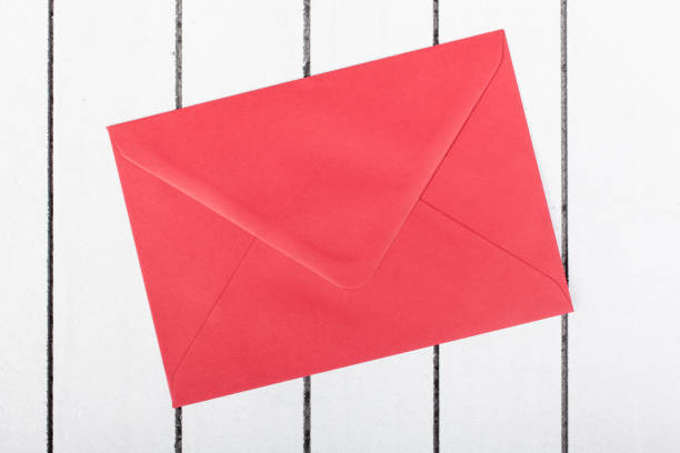 istock red envelope on white wooden background 640345546