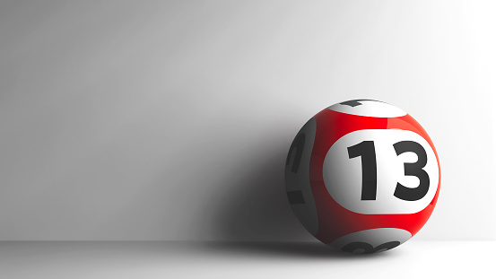 Red lottery ball with number 13 on grey background, three-dimensional rendering, 3D illustration