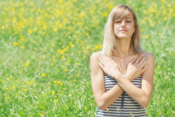 istock Girl meditating in the field. 640349714
