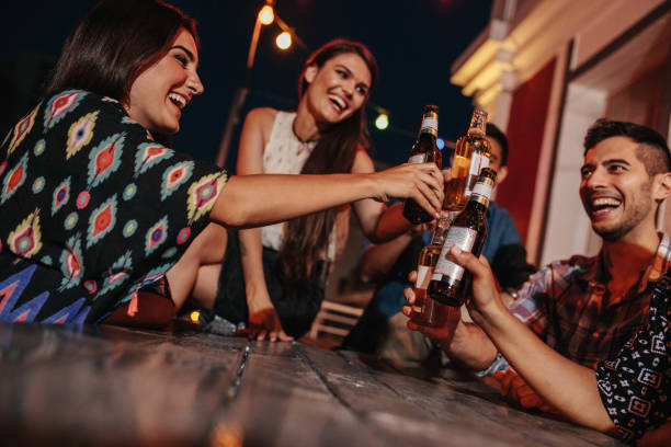 istock Group of friends toasting drinks at party in evening 640351032