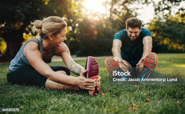 Photo libre de droit de Jeune Couple De Race Blanche Faisant De Lexercice Dans Le Parc banque d'images et plus d'images libres de droit de Exercice physique